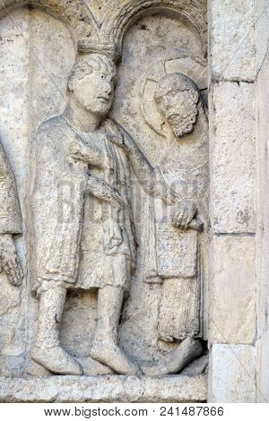 MODENA, ITALY - JUNE 04: Plate with stories from Genesis: Story about Abel and Cain, God the Father reproaches Cain, relief by Wiligelmo, Modena Cathedral, Italy on June 04, 2017.