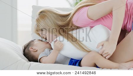 Mommy Play With Son On Sofa At Home