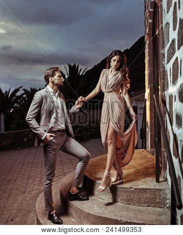 Young lover posing on night city background 