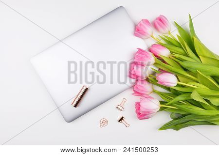 Feminine Flat Lay, Top View Workspace With Tulips Flowers Bouquet, Laptop And Accessories On White B