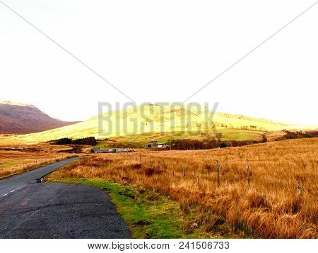 View Over  Autumnal Orange Bare Landscape, Sinle Road,  Meanders, High  Rocky Hills And Past Pasture