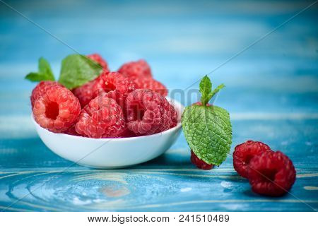 Ripe And Sweet Raspberries In A White Dish