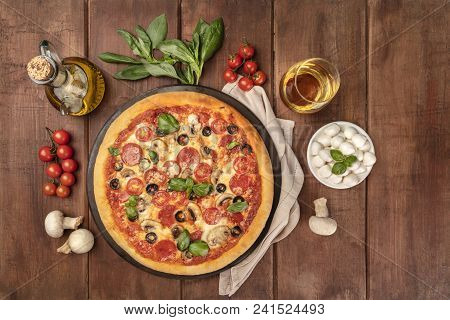 Overhead Photo Of Pepperoni Pizza With Glass Of White Wine, Olive Oil, Basil Leaves, Mushrooms, Cher