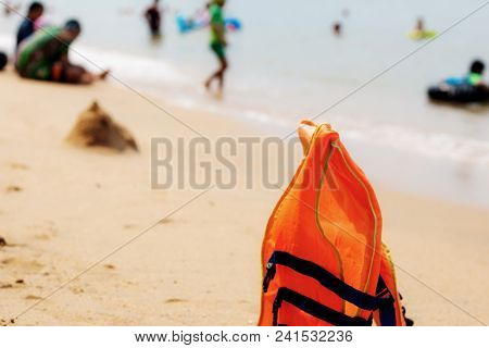 Life Jacket On Sand Beach At The Sea.