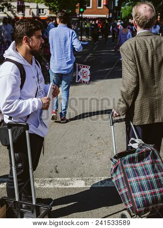 Windsor, United Kingdom - May 19, 2018: Man Sells Royal Couple Portrait Souvenirs During Royal Weddi