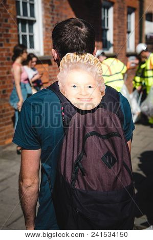 Windsor, Berkshire, United Kingdom - May 19, 2018: Man With Masks Of Queen Elizabeth Ii Heading Roya