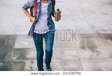 Woman Walking With Coffee Themo Cup In Hand