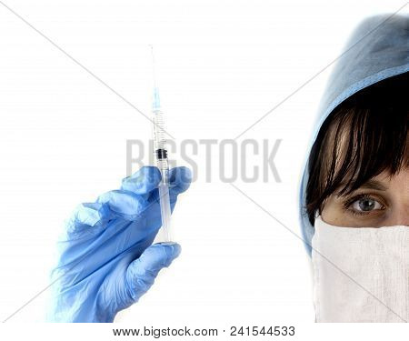 Girl Doctor In Mask And Cap With Syringe In Hands On White Background, Close-up
