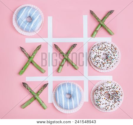 Tik Tak Toe Game With Donuts And Asparagus. Health Nutrition Concept Image