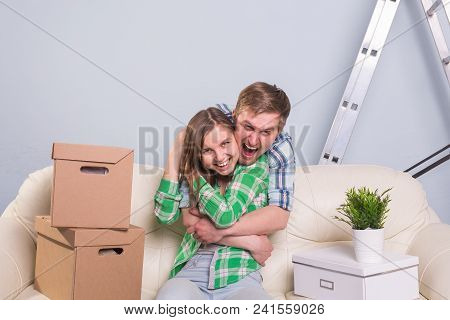 Young Cheerful Couple Moving Into Their New Home.