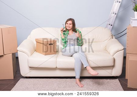 Beautiful Woman With Boxes And Holding Flat Keys