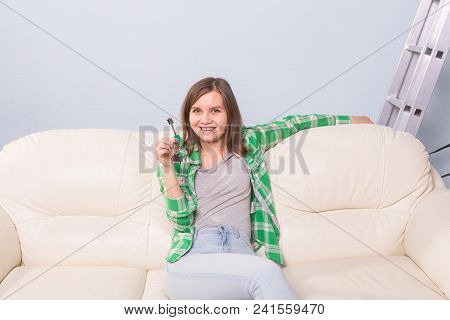 Happy Woman In Her New Home Holding Key
