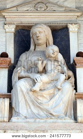 VERONA, ITALY - MAY 27: Virgin Mary with baby Jesus, statue on the facade of Palazzo del Vescovado, Verona Diocesan Palace, Italy, on May 27, 2017.