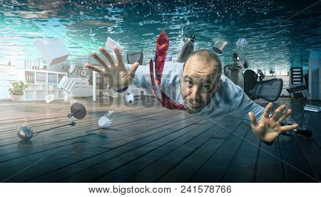 businessman swimmin a flooded office
