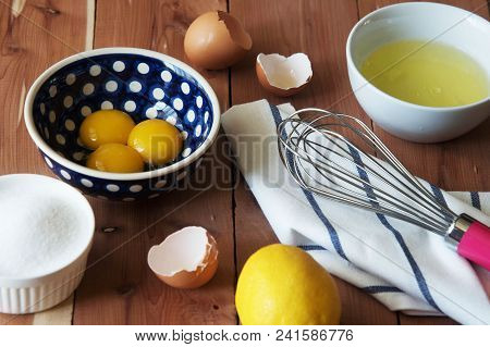 Separation The Yolk Of Egg In Little Bowl And And Preparation For The Whisking Of Egg Whites And Yol