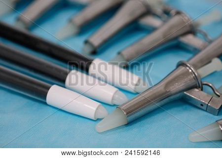 Anoscopes, Proctoscopes And Rectoscopes On Blue Medical Tablecloth