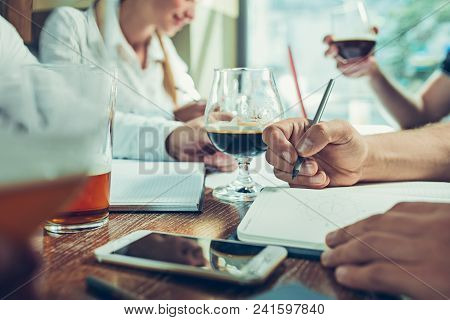 Young Cheerful People Smile And Gesture While Relaxing In Pub. Team Job. Photo Young And Mature Busi