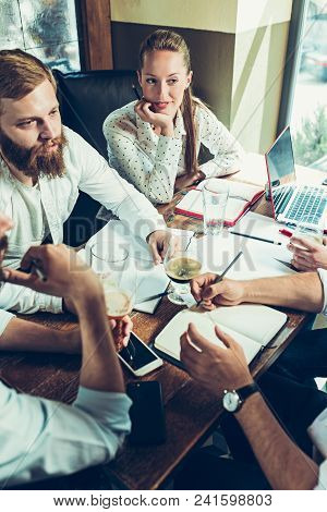Young Cheerful People Smile And Gesture While Relaxing In Pub. Team Job. Photo Young And Mature Busi