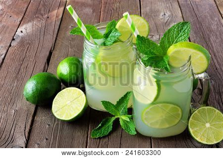 Limeade In Mason Jar Glasses On A Rustic Wood Background