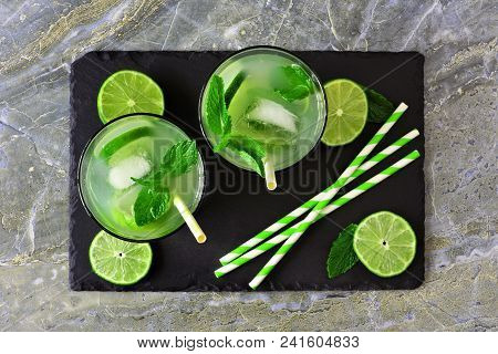 Summer Limeade In Two Glasses. Top View On A Slate Server Against A Dark Background.