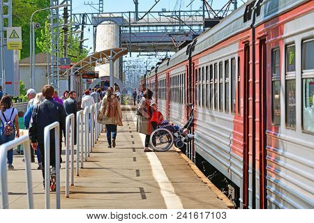 Skhodnya, Russia - May 09. 2018. A Man In A Wheelchair Enters A Train.