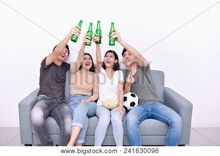 Concept Of Cheering. Asian Teenagers Watching Football On Television. People Are Cheering And Winnin
