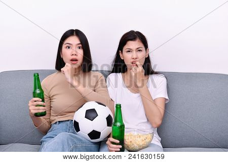 Concept Of Cheering. Asian Teenagers Watching Football On Television. People Are Cheering And Winnin