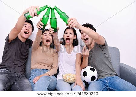Concept Of Cheering. Asian Teenagers Watching Football On Television. People Are Cheering And Winnin