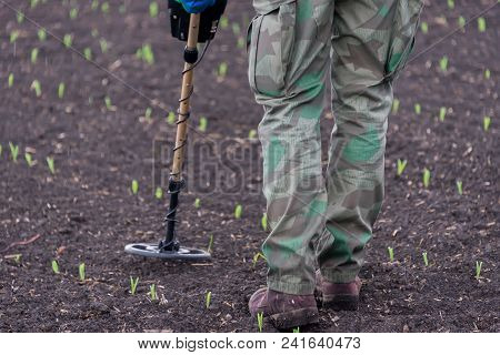 Man To Seek Treasure On Earth With A Metal Detector, Walks The Field, Squeak Gold