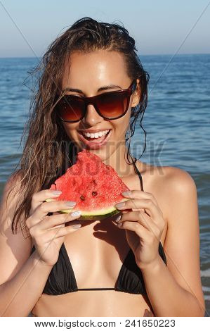 Summer Vacation - Young Girl Eating Fresh Watermelon On Sandy Beach