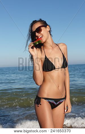 Summer Vacation - Young Girl Eating Fresh Watermelon On Sandy Beach