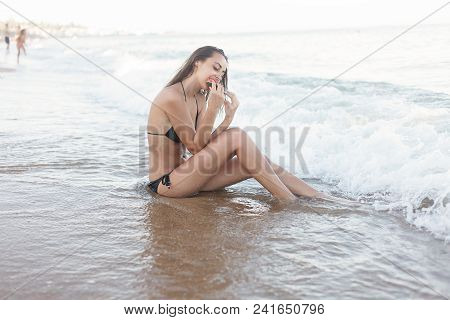 Summer Vacation - Young Girl Eating Fresh Watermelon On Sandy Beach