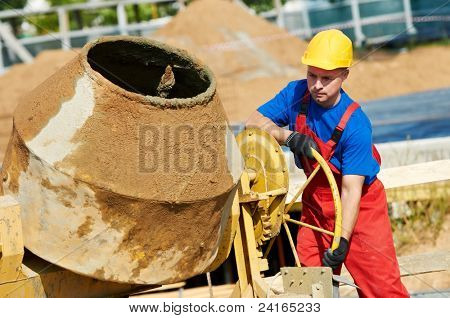 Konstruktor robotnik mężczyzna pracujący z przodu Beton cement mixer w budowie