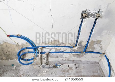 Water Pipes Made Of Polypropylene Pex In The Wall, Plumbing In The House. Installation Of Sewer Pipe