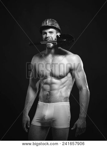 Professional Builder With Shovel In Hart Hat. Muscular Construction Worker, Labourer, Workman, Repai