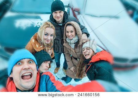 Selfies Of A Group Of Young People In Winter On The Background Of Cars