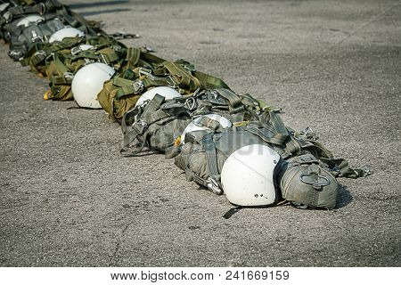 Row Of T-10 Tactical Parachute Bag With Parachute Reserve And Helmet On Ground Prepare For Paratroop