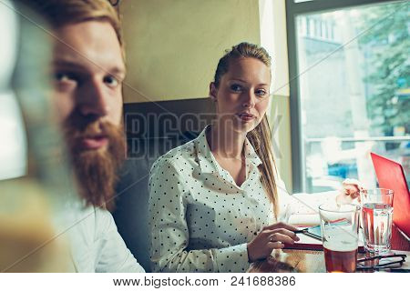 Young Cheerful People Smile And Gesture While Relaxing In Pub. Team Job. Photo Young And Mature Busi
