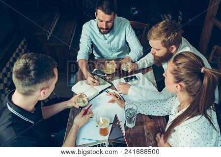 Young Cheerful People Smile And Gesture While Relaxing In Pub. Team Job. Photo Young And Mature Busi