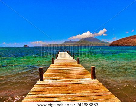 Disappearing Wooden Jetty Into The Caribbean Sea