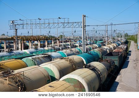 Railway Landscape With Many Old Railway Freight Cars On Rails On A Sunny Day Close Up.