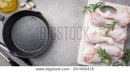 Raw Chicken Legs With Herbs And Spices On Cutting Board. Top View. Gray Background