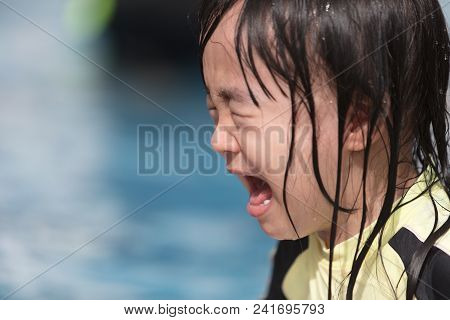 Asian Little Chinese Girl Crying In Swimming Pool Outdoor