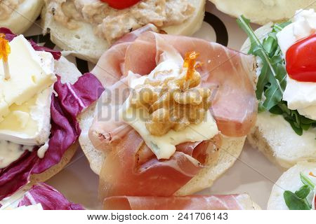 Bread Called Canape Or Tartine With Nut And Raw Ham At European Party