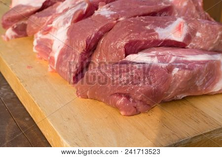 Raw Fat Cuting Pieces Of Pork On Wooden Background. Piece Of Fresh Boneless Pork, Neck Part Or Colla