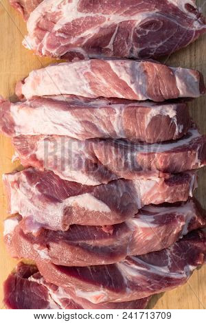 Raw Fat Cuting Pieces Of Pork On Wooden Background. Piece Of Fresh Boneless Pork, Neck Part Or Colla