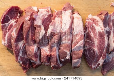 Raw Fat Cuting Pieces Of Pork On Wooden Background. Piece Of Fresh Boneless Pork, Neck Part Or Colla