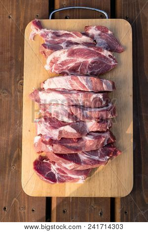 Raw Fat Cuting Pieces Of Pork On Wooden Background. Piece Of Fresh Boneless Pork, Neck Part Or Colla