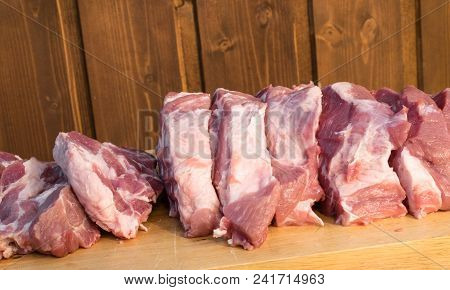 Raw Fat Cuting Pieces Of Pork On Wooden Background. Piece Of Fresh Boneless Pork, Neck Part Or Colla