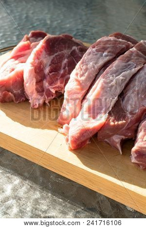 Raw Fat Cuting Pieces Of Pork On Wooden Background. Piece Of Fresh Boneless Pork, Neck Part Or Colla